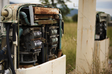 Old rustic fuel pump in the countryside.