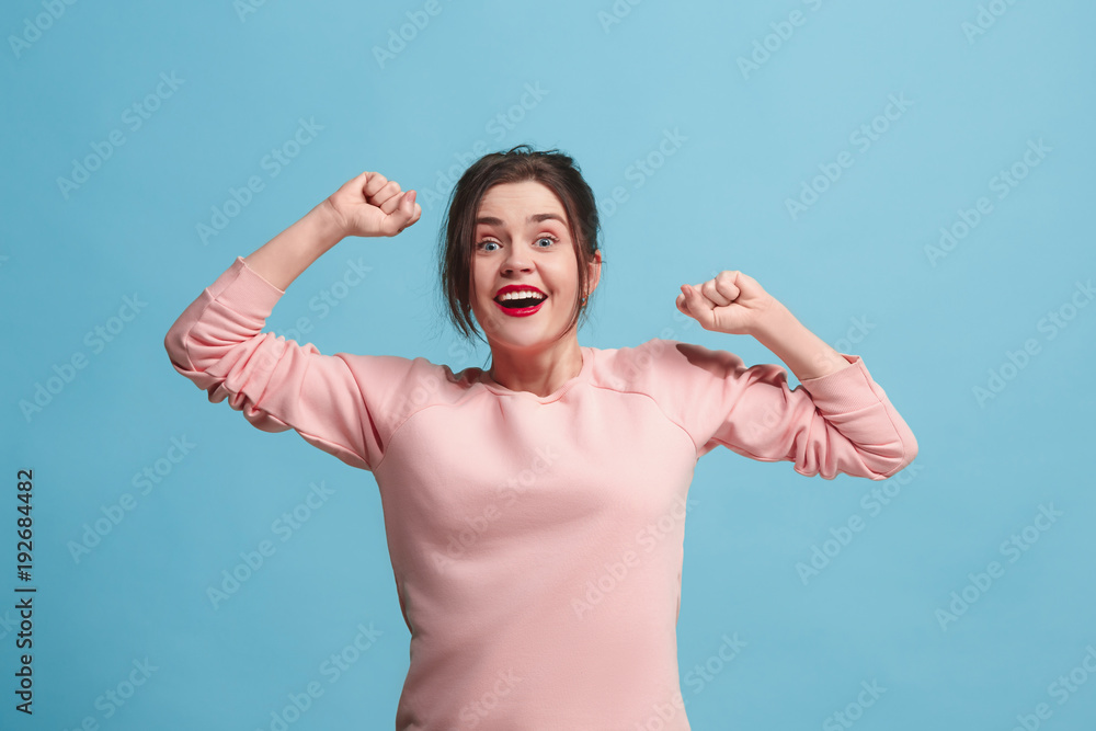 Wall mural Winning success woman happy ecstatic celebrating being a winner. Dynamic energetic image of female model