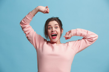 Winning success woman happy ecstatic celebrating being a winner. Dynamic energetic image of female model