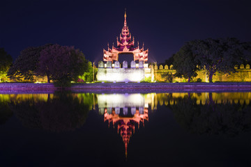 Defensive bastion with a tower in the night illumination. Mandalay, Myanmar (Burma)