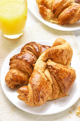 Fresh hot croissants and orange juice for breakfast