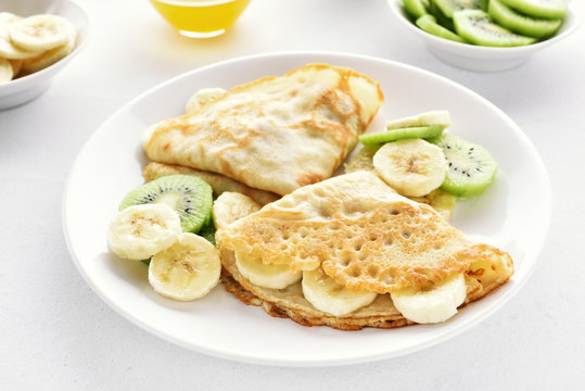 Crepes with banana and kiwi slices