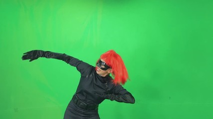 4k Green-screen girl with red hair blows by hand outside in karate style martial arts - Powered by Adobe