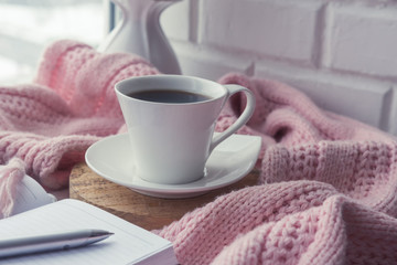 cozy soft pink blanket with a cup of coffee near the window, concept of rest