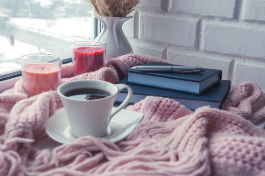 cozy soft pink blanket with a cup of coffee near the window, concept of rest