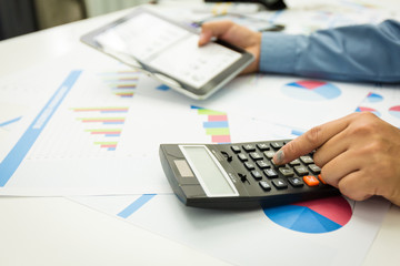 Businessman using a personal income tax calculator.