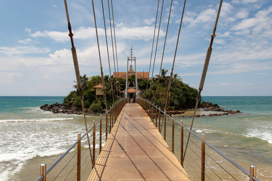 Bridge to Matara Parevi Duwa buddhist temple, perspective view, Sri Lanka.