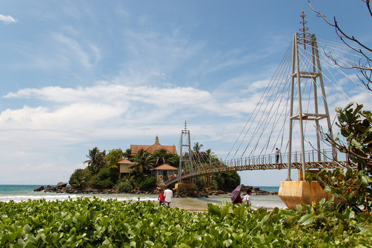 Bridge to Matara Parevi Duwa buddhist temple and beutiful sky, Sri Lanka.
