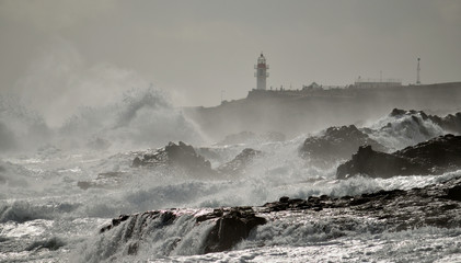Fototapeta na wymiar Coast of Gran canaria with strong swell and lighthouse, La Garita, Canary islands