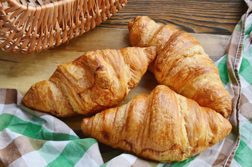 Corissants in the basket on wooden background