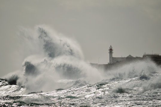 Strong waves and lighthouse in background, Taliarte, coast of Telde, Canary islands