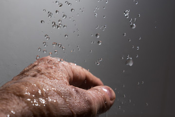 Human hand and splahing water.
