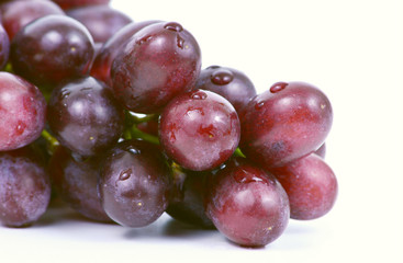 close up Purple grapes with water drops on white background