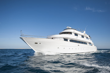 Plakat Luxury private motor yacht sailing at sea
