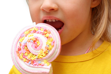 the girl eats candy on a stick on white background