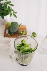 Making green smoothie. Natural, organic healthy juice in bottle for weight loss diet