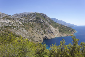 Fototapeta na wymiar Dalmatian coastline with its cliff and streets through mountains, by the sea