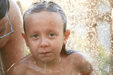water fun. girl in the shower splashing water.