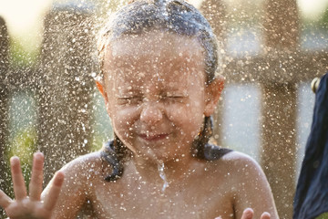 water fun. girl in the shower splashing water.