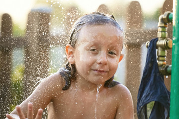 Fototapeta premium water fun. girl in the shower splashing water.