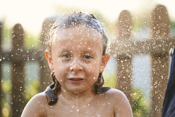 water fun. girl in the shower splashing water.