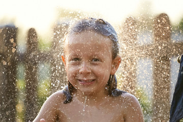 water fun. girl in the shower splashing water.