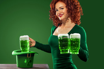 Saint Patricks Day. Young ginger Oktoberfest leprechaun, wearing grenn dress, serving big beer mugs...