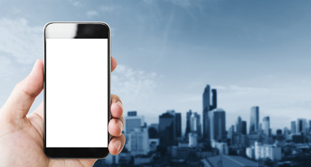Hand holding mobile smart phone, blank white screen, blue city background