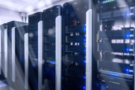 Web network, internet telecommunication technology, big data storage, cloud computing computer service business concept: server room interior in datacenter in blue light. 