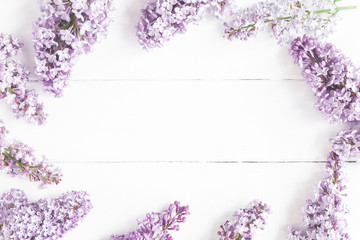 Flowers composition. Spring lilac flowers on white wooden background. Flat lay, top view, copy space