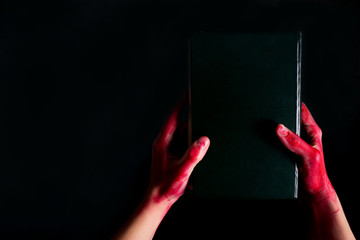 Alchemy book with bloody hand