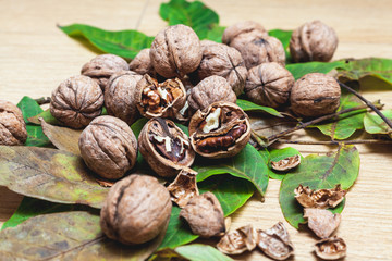 Several walnuts lie on brown background