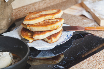 Several mouthwatering fried patties stacked on plate