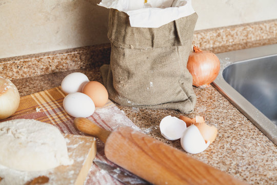 bag eggs and rolling pin lying on kitchen table