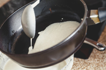 liquid dough is poured onto frying pan
