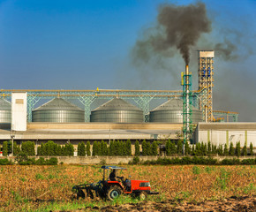 Agricultural silos with thick smoke from pipe emissions pollutio
