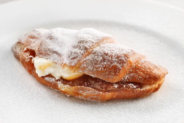 croissant with jam on white plate