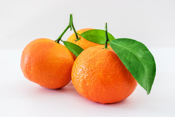 Ripe mandarines citrus with green leaves isolated on white background