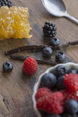 Berries, Vanilla Bean and Honeycomb on wooden surface