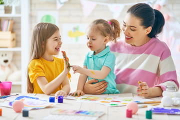 Fototapeta premium Mother and daughters painting together