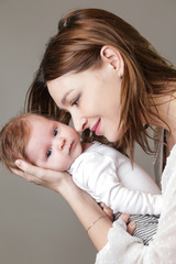 Mother holding her newborn baby 
