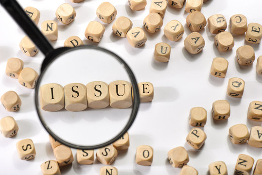 Issue word on wooden cubes. Issue concept