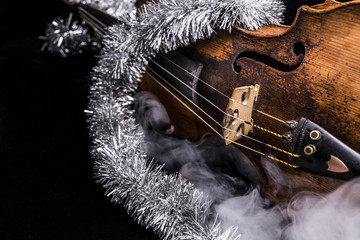 A violin with a Christmas decoration
