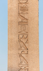 ancient egyptian obelisk with patterns and hieroglyph