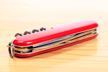 Swiss knife on a wooden background