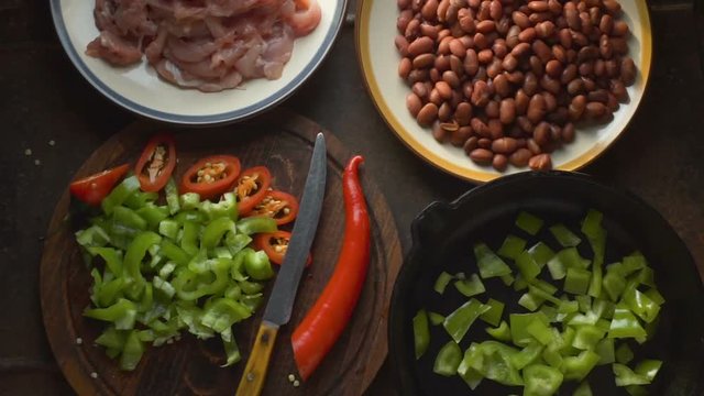 Pieces of chicken, beans and peppers on the table close-up. Video