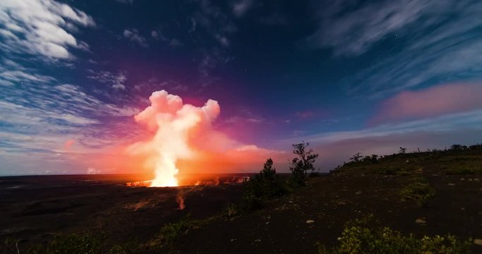 timelapse footage of steam and smoke rising from kilauea crater in volcano national park on big island of hawaii in the pacific ocean showing the red and orange glow against the night sky and clouds