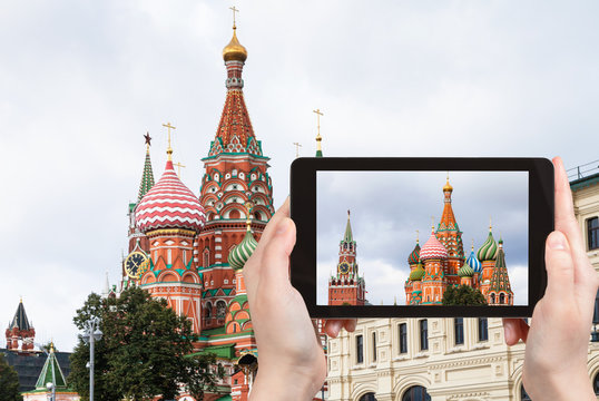 tourist photographs St Basil Cathedral in Moscow