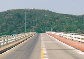 Road bridge over the sea mountainous background