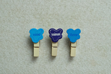 Nine minus three on a white background